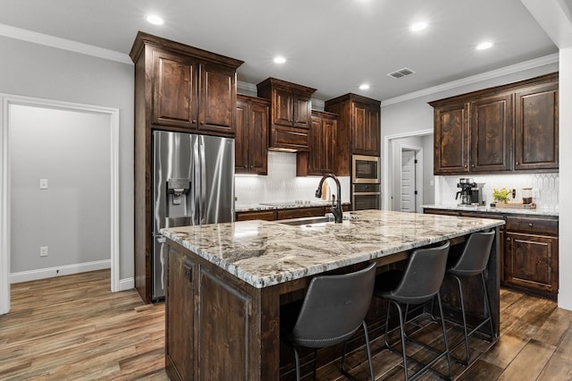 10009 Wildberry Dr, Waco, TX 76712 - kitchen featuring stainless steel appliances, visible vents, a sink, and wood finished floors