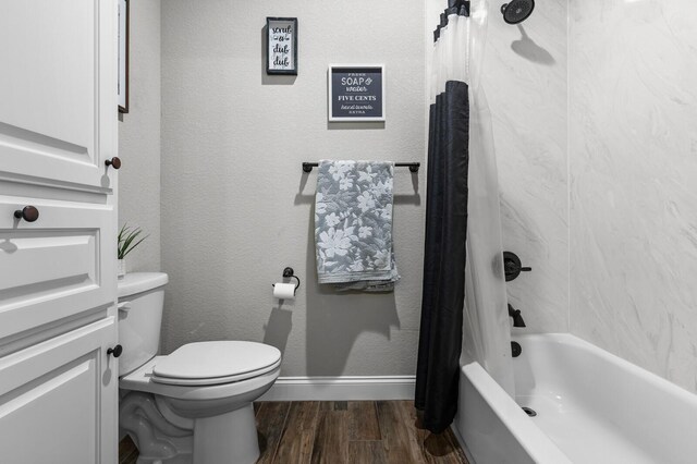 10009 Wildberry Dr, Waco, TX 76712 - full bath featuring toilet, baseboards, shower / tub combo with curtain, and wood finished floors