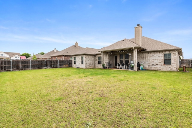 10009 Wildberry Dr, Waco, TX 76712 - rear view of property featuring a fenced backyard, a patio area, brick siding, and a yard