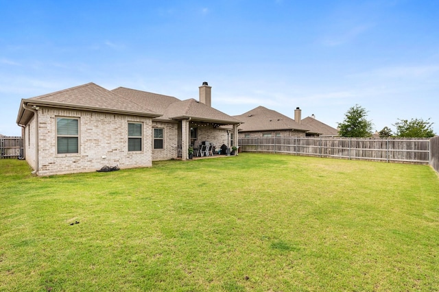 10009 Wildberry Dr, Waco, TX 76712 - rear view of house featuring a lawn, brick siding, and a fenced backyard