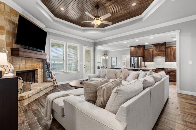 10009 Wildberry Dr, Waco, TX 76712 - living area featuring wood ceiling, wood finished floors, a tray ceiling, crown molding, and baseboards