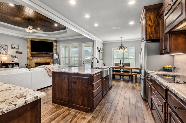 10009 Wildberry Dr, Waco, TX 76712 - kitchen with a sink, ceiling fan with notable chandelier, visible vents, dark wood-style flooring, and black electric cooktop