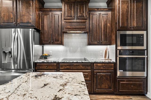 10009 Wildberry Dr, Waco, TX 76712 - kitchen featuring light stone countertops, crown molding, stainless steel appliances, and tasteful backsplash