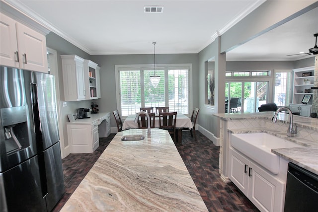 kitchen featuring stainless steel fridge, dishwasher, visible vents, and a sink