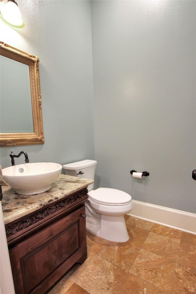 bathroom featuring toilet and vanity