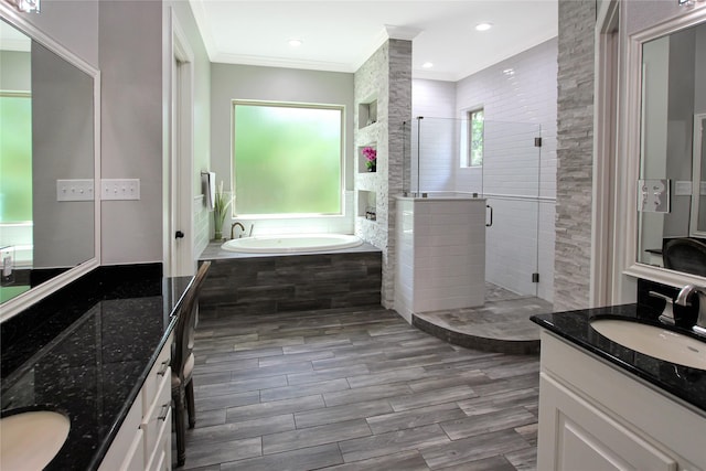 full bathroom with a shower stall, a sink, a bath, ornamental molding, and two vanities