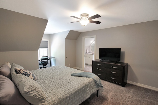 bedroom featuring baseboards, light colored carpet, ceiling fan, and connected bathroom