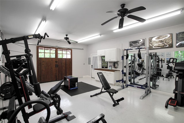 exercise room with a ceiling fan