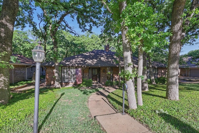 5112 River Ridge Rd, Arlington, TX 76017 - view of front of property featuring brick siding, a front yard, and a chimney