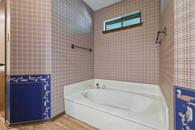 5112 River Ridge Rd, Arlington, TX 76017 - bathroom with a bath and wood finished floors
