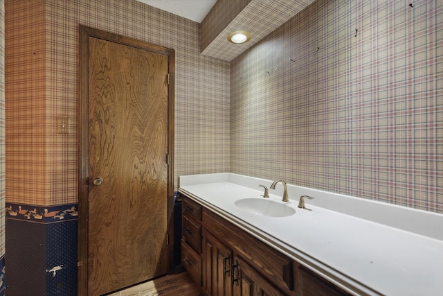 5112 River Ridge Rd, Arlington, TX 76017 - bathroom featuring wallpapered walls, wood finished floors, and vanity