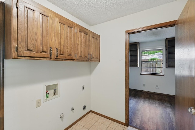5112 River Ridge Rd, Arlington, TX 76017 - washroom with hookup for a washing machine, gas dryer hookup, cabinet space, a textured ceiling, and electric dryer hookup