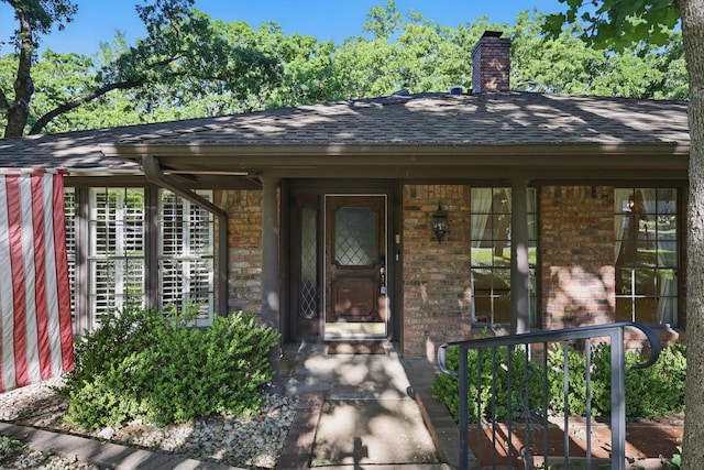 5112 River Ridge Rd, Arlington, TX 76017 - entrance to property featuring brick siding, roof with shingles, a chimney, and a porch