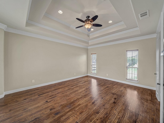 spare room with plenty of natural light, visible vents, a ceiling fan, and dark wood-style flooring