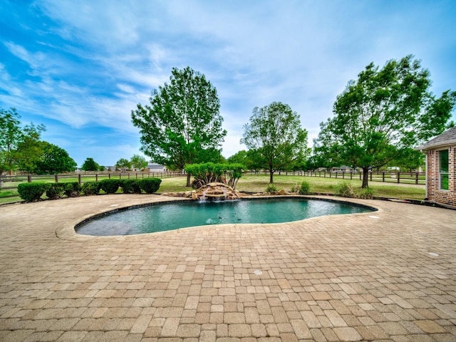 outdoor pool with fence and a patio