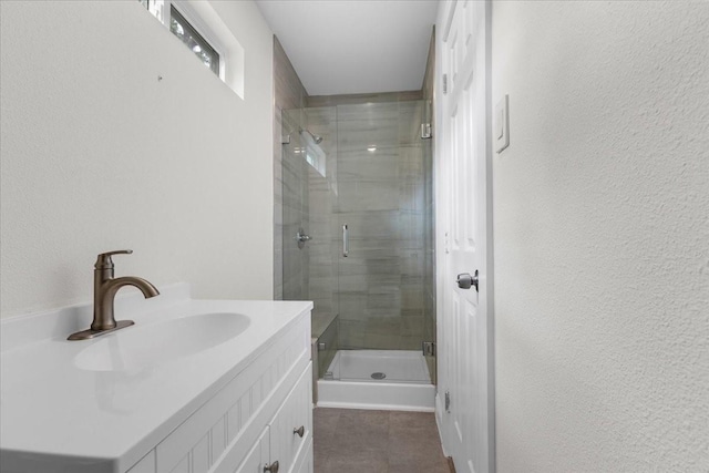 1125 Rodeo Center Blvd, Mesquite, TX 75149 - full bathroom featuring a stall shower, tile patterned flooring, vanity, and a textured wall