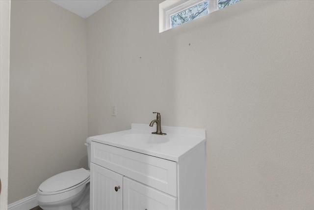 1125 Rodeo Center Blvd, Mesquite, TX 75149 - half bathroom featuring vanity, toilet, and baseboards