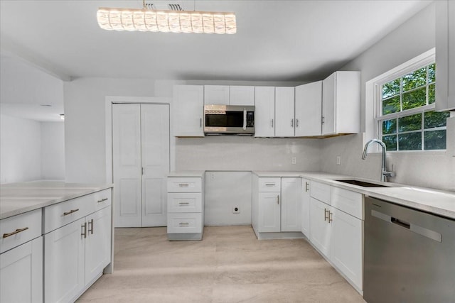 1125 Rodeo Center Blvd, Mesquite, TX 75149 - kitchen featuring appliances with stainless steel finishes, a sink, and white cabinets