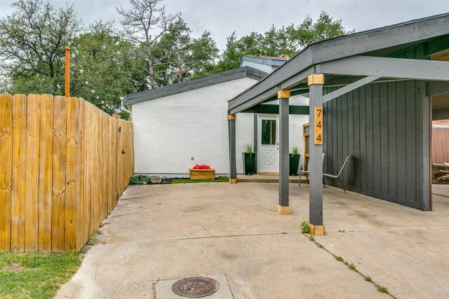 view of patio featuring fence and driveway