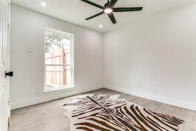 unfurnished room with light wood finished floors, a ceiling fan, baseboards, and recessed lighting