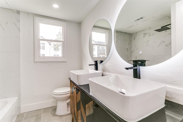 full bathroom featuring toilet, a sink, visible vents, and baseboards