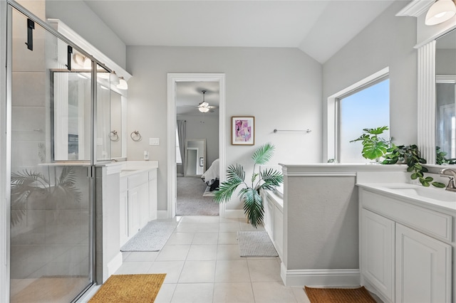 ensuite bathroom with vanity, a stall shower, ceiling fan, tile patterned flooring, and vaulted ceiling