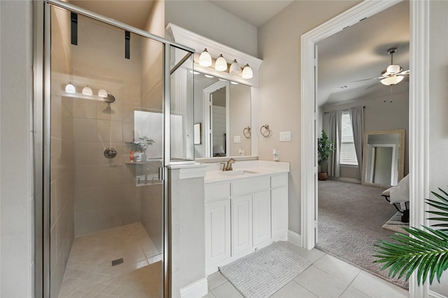 full bathroom featuring a shower stall, tile patterned floors, ceiling fan, vanity, and baseboards