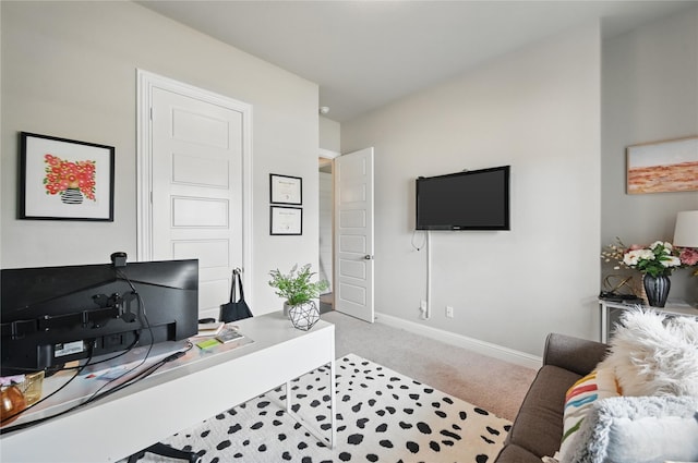 living area with carpet, an office area, and baseboards