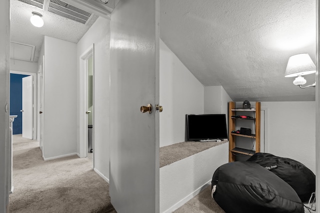 bonus room featuring carpet, vaulted ceiling, visible vents, and a textured ceiling