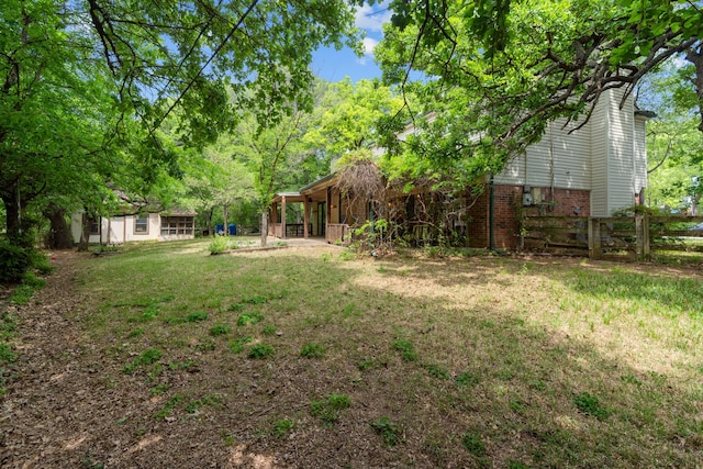 view of yard with an outdoor structure and fence