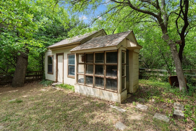 view of outdoor structure featuring an outbuilding and fence