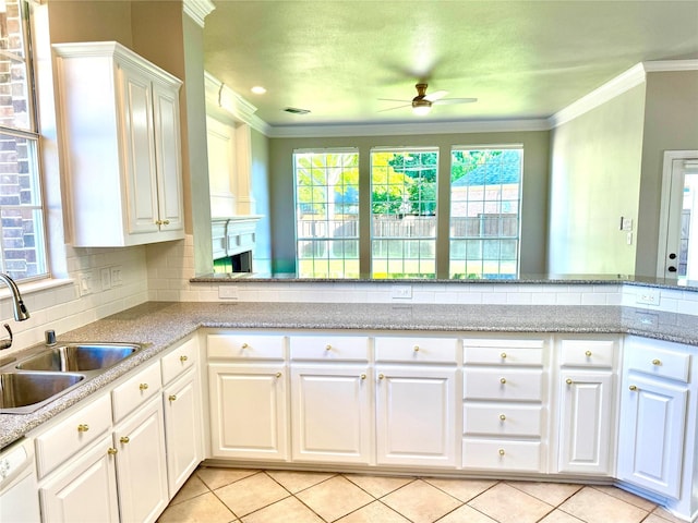 611 Twin Creek Dr, Allen, TX 75013 - kitchen featuring a sink, ceiling fan, light tile patterned floors, crown molding, and decorative backsplash
