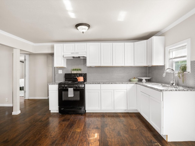 kitchen featuring under cabinet range hood, a sink, light stone countertops, tasteful backsplash, and black range with gas cooktop