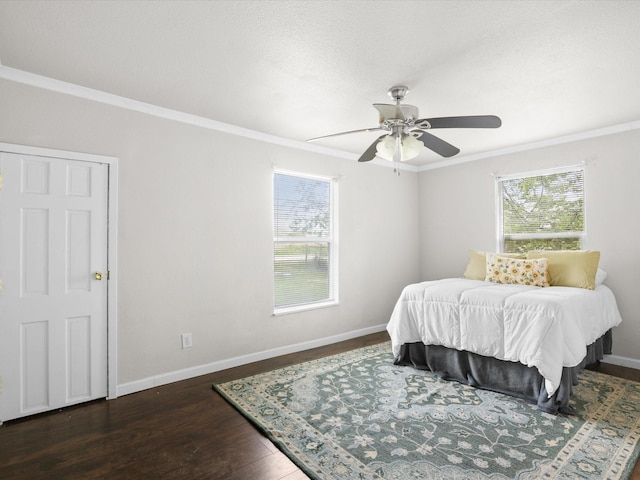 bedroom featuring baseboards, dark wood-style floors, ornamental molding, and multiple windows