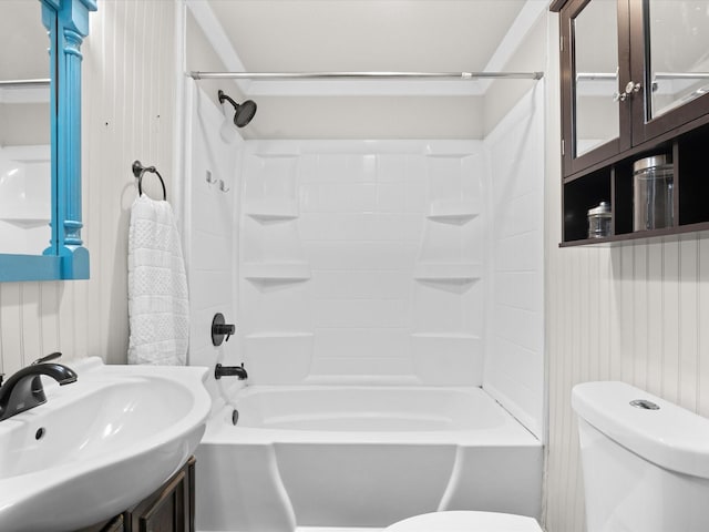 bathroom featuring toilet, washtub / shower combination, and a sink