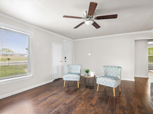 sitting room featuring wood finished floors, a ceiling fan, baseboards, and ornamental molding
