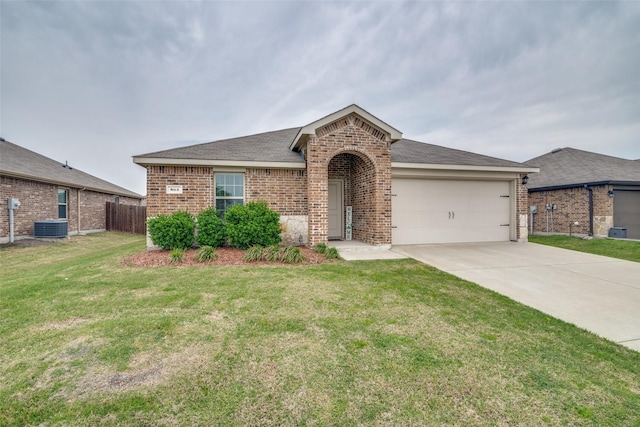 view of front facade featuring fence, a front lawn, concrete driveway, brick siding, and a garage