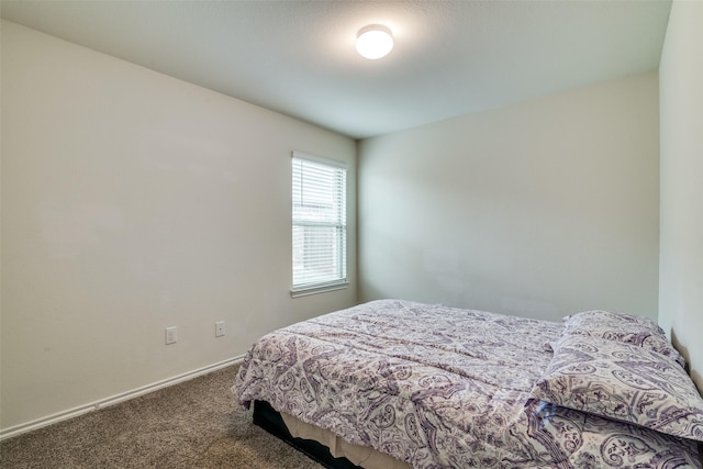 bedroom featuring baseboards and carpet floors