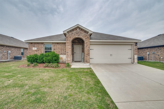 view of front of home with central air condition unit, concrete driveway, brick siding, an attached garage, and a front yard
