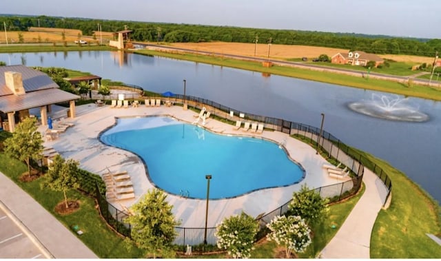 pool featuring fence and a water view