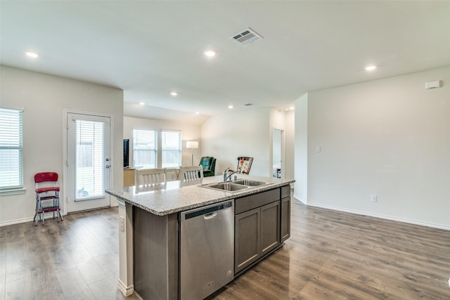 kitchen with stainless steel dishwasher, dark wood-style flooring, a sink, and visible vents
