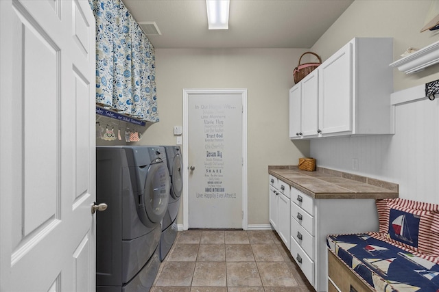 laundry room featuring cabinet space, visible vents, baseboards, and separate washer and dryer