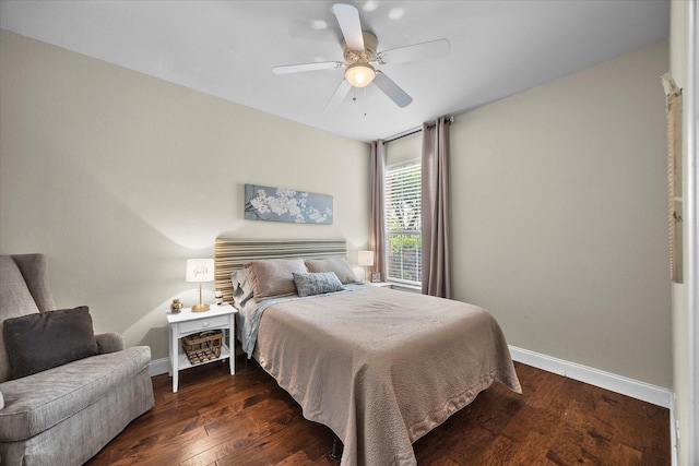 bedroom with ceiling fan, baseboards, and wood finished floors