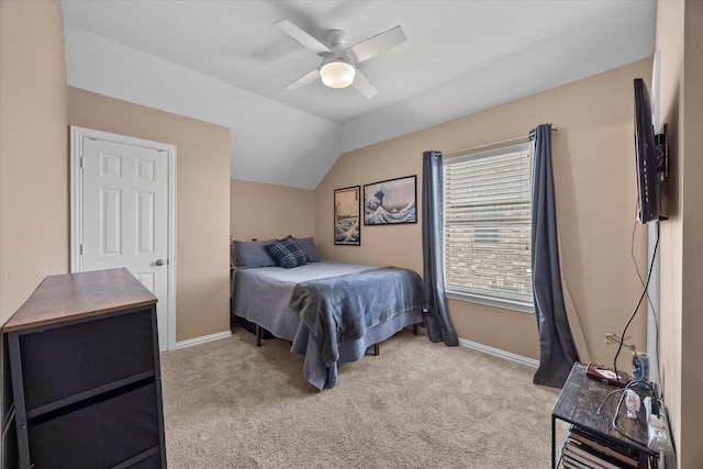 bedroom with baseboards, lofted ceiling, light colored carpet, and ceiling fan