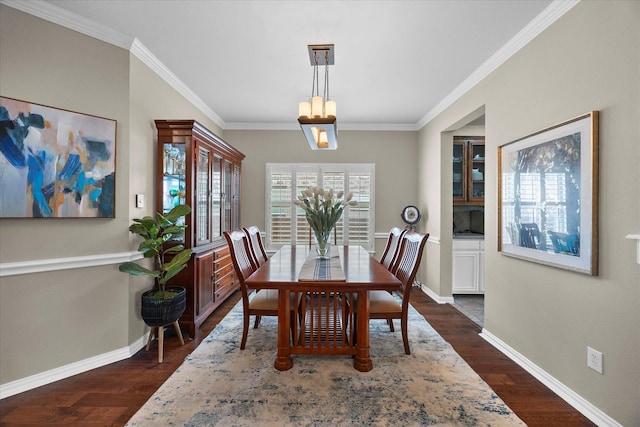 dining space featuring baseboards, ornamental molding, and dark wood-style flooring
