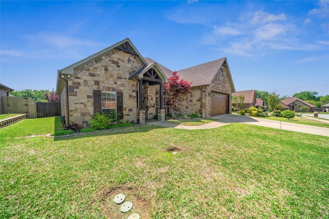 view of front of home with fence, a front lawn, driveway, and stone siding