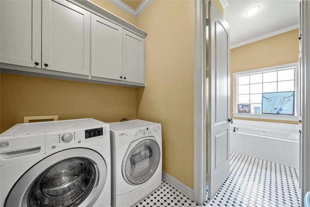 laundry area with cabinet space, crown molding, baseboards, and separate washer and dryer