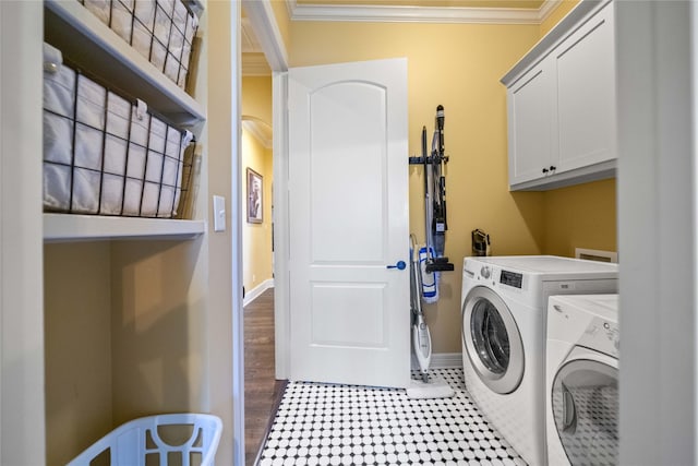 laundry room with separate washer and dryer, baseboards, ornamental molding, and cabinet space