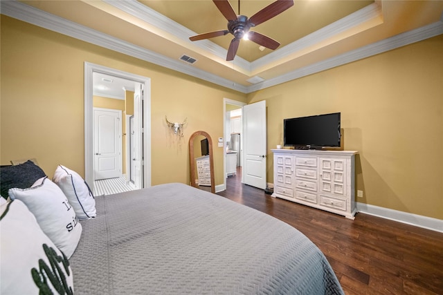 bedroom featuring visible vents, a raised ceiling, baseboards, ornamental molding, and dark wood-style floors