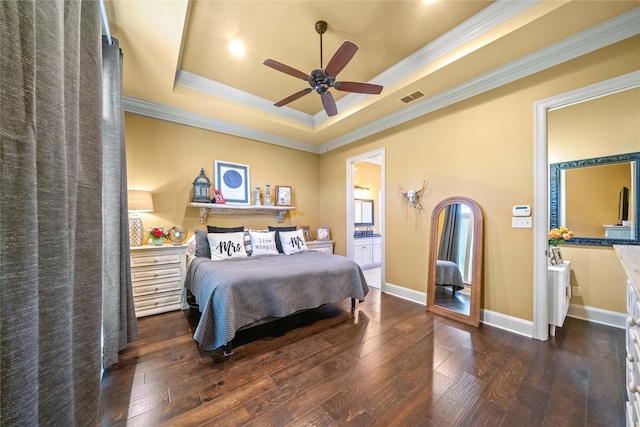 bedroom featuring ornamental molding, visible vents, a raised ceiling, and wood-type flooring